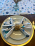 Blue dreidel Hanukkah cloth napkins on a set holiday table.