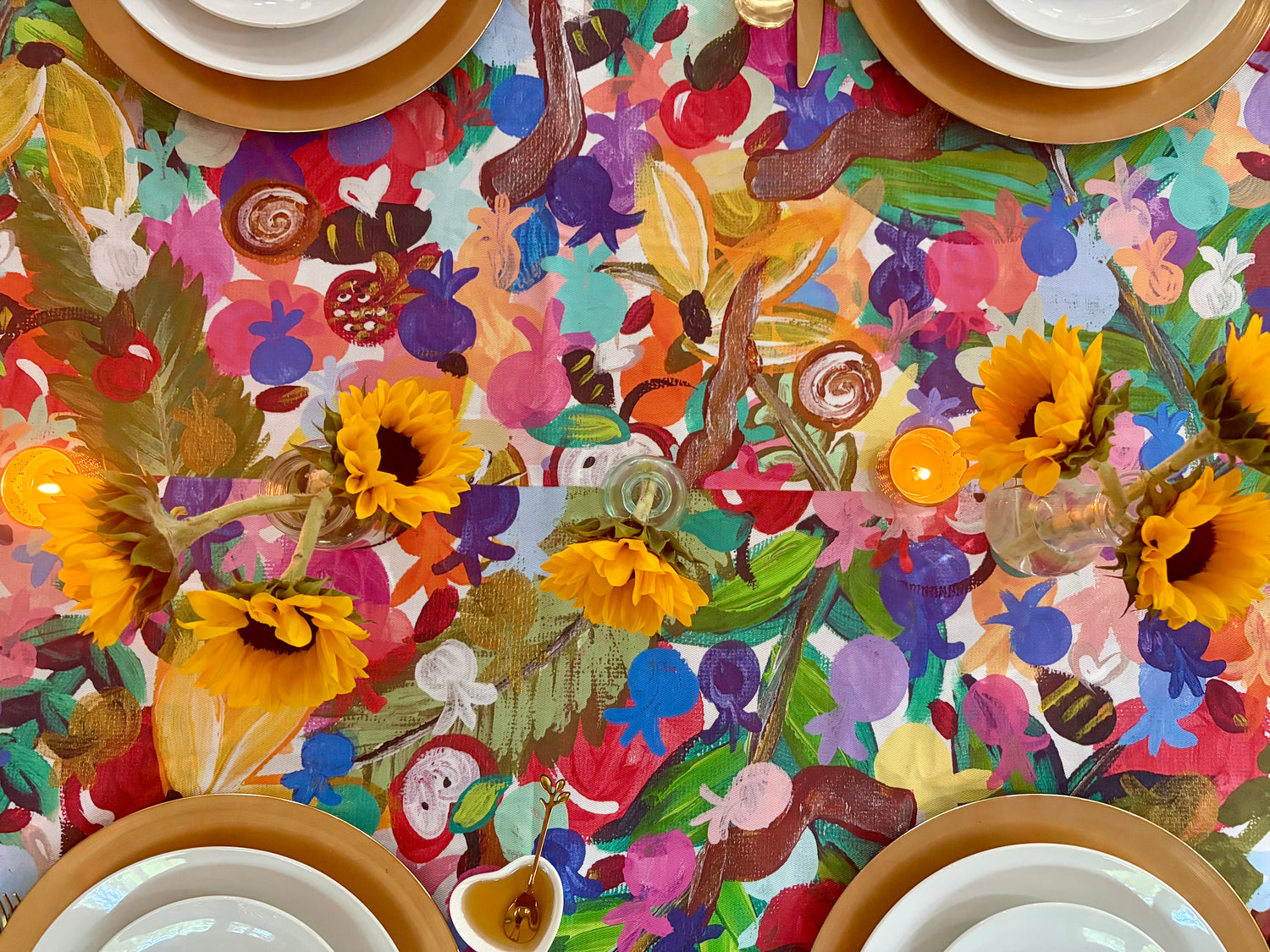 The 613 Tablecloth styled for a colorful Rosh Hashanah table